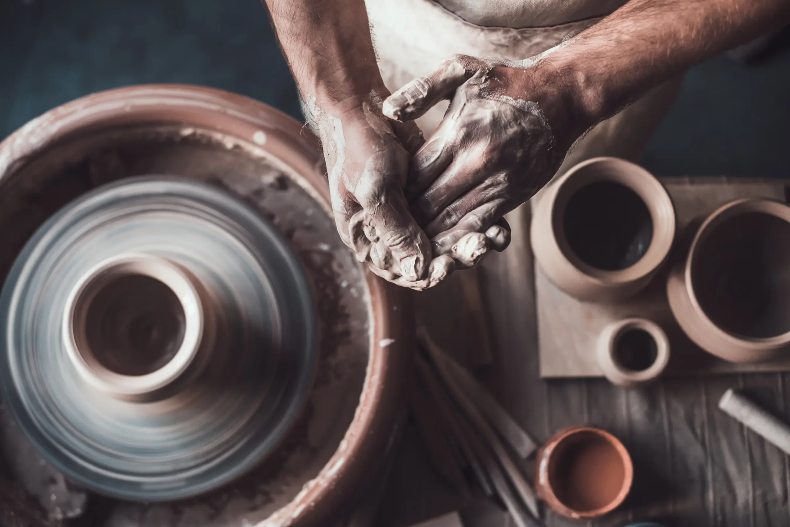 Pottery studio Manassas VA potter shaping clay pot in progress handmade ceramics at Manassas Clay studio