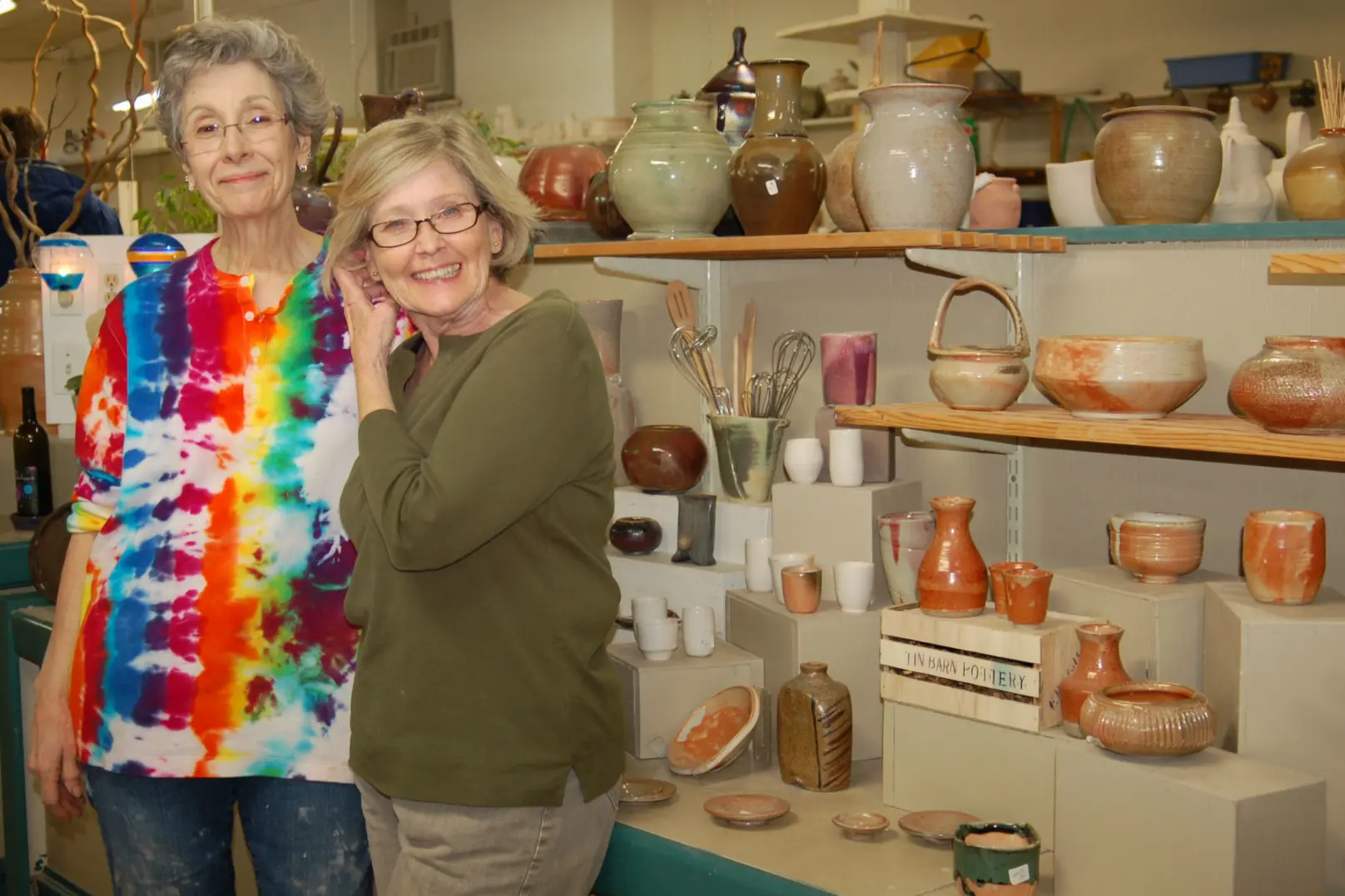 Manassas Clay pottery studio Manassas VA owners Jane and Fran with ceramic artwork display